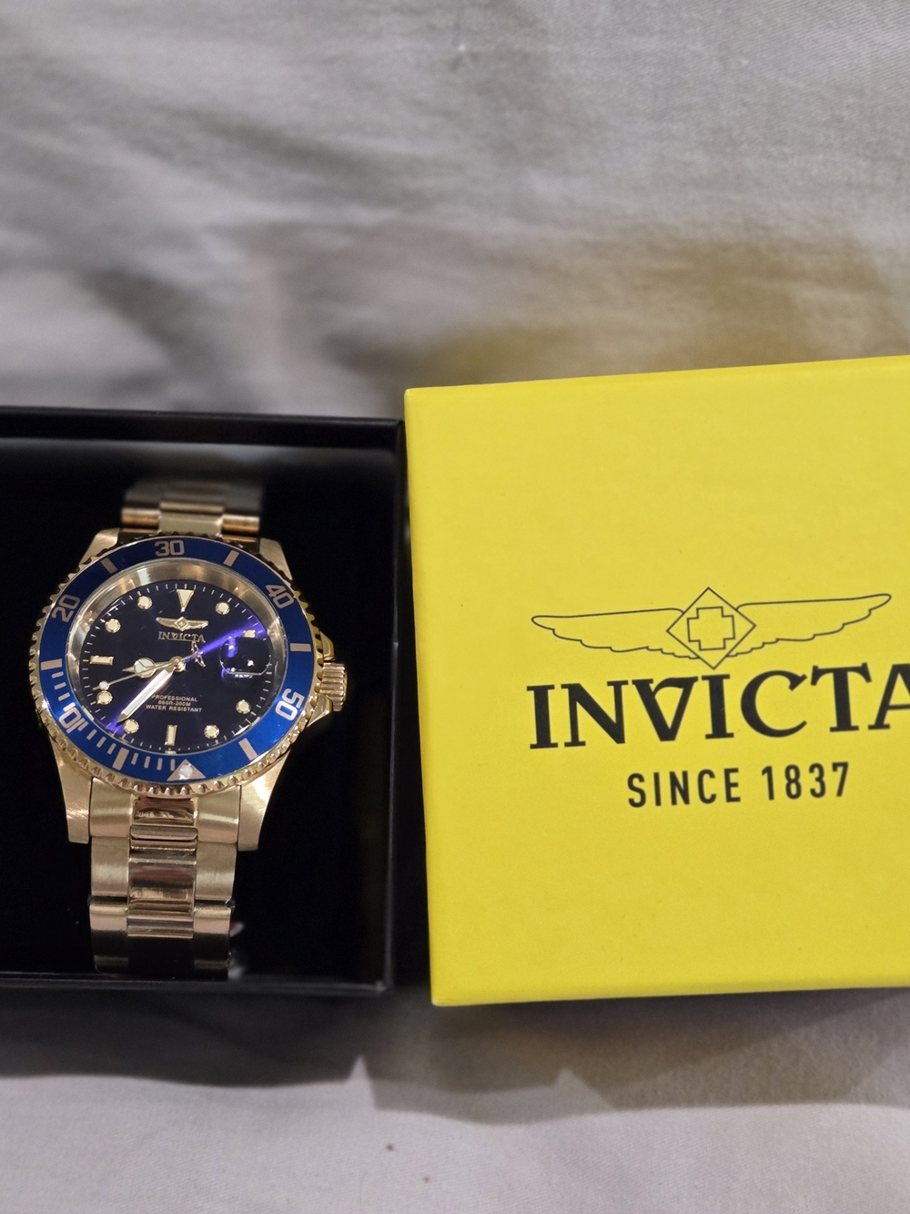 Invicta Gold and Blue Stainless Steel Watch with Yellow Brand Tag